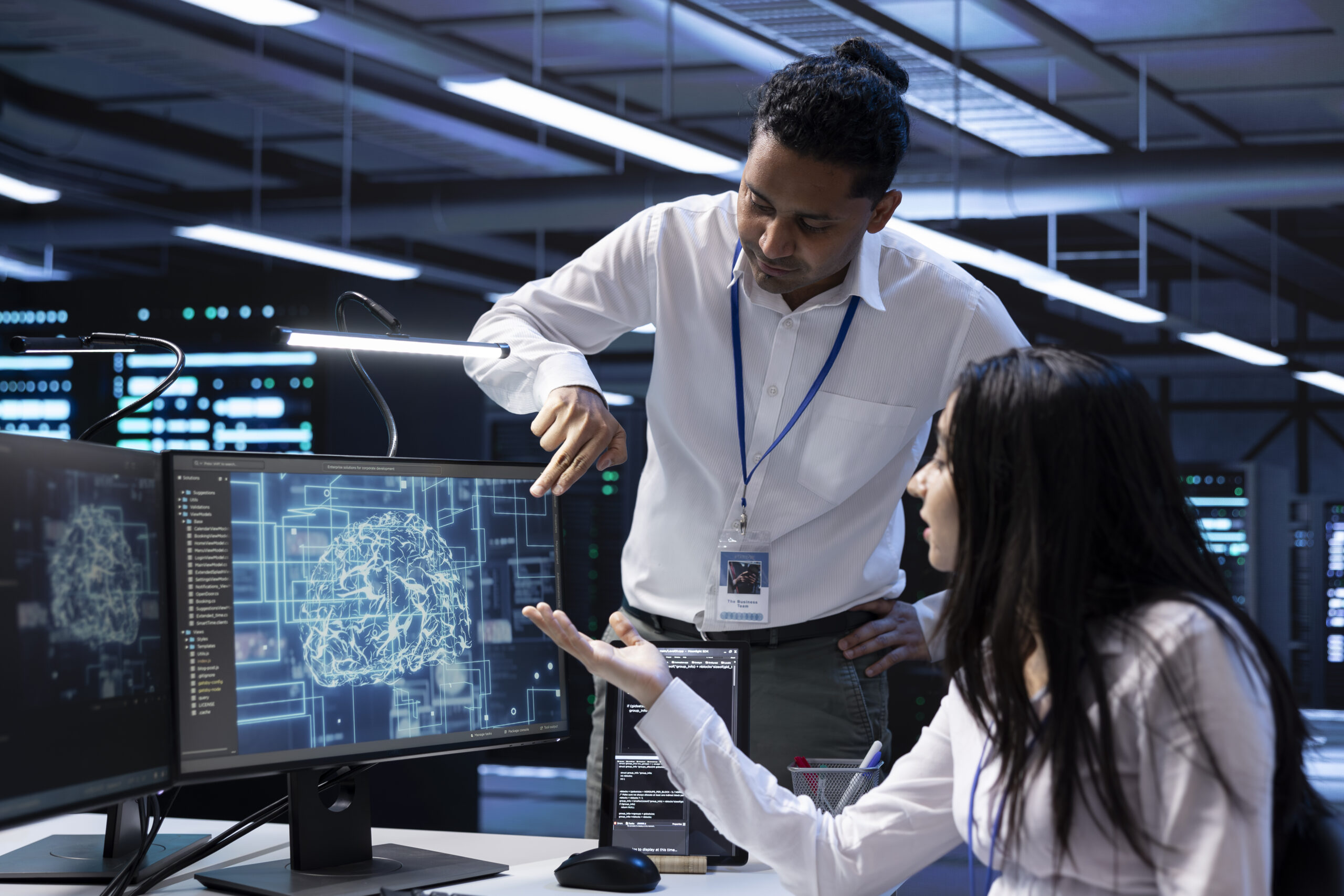 Team of data researchers using AI tech to do checkup in server room providing storage. Teamworking colleagues in data center using PC to enable artificial intelligence to process datasets for training